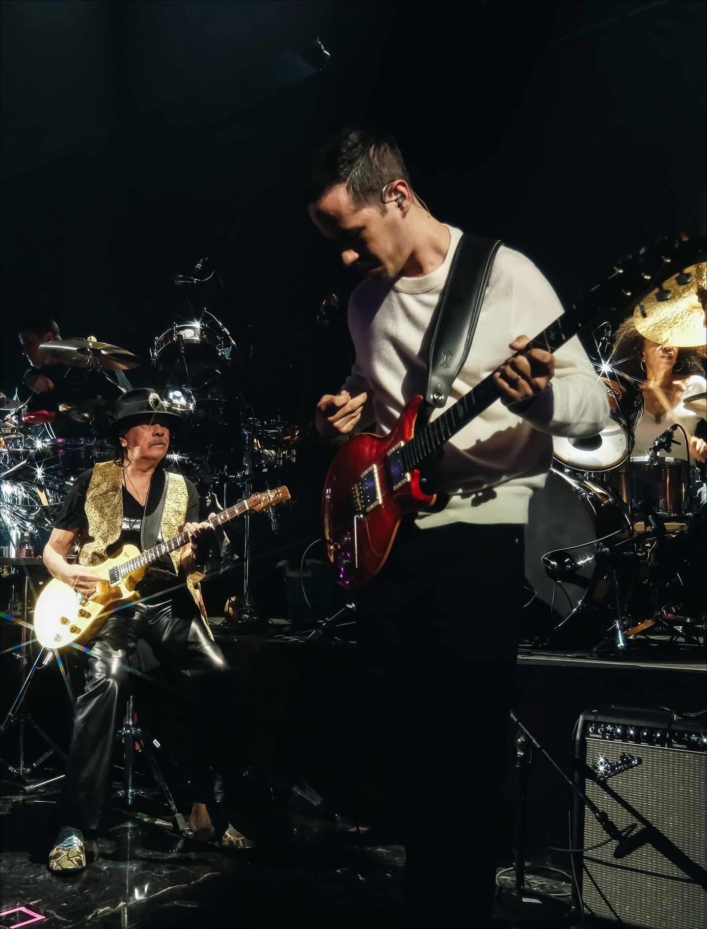 Edgar Barrera performing alongside Carlos Santana on stage